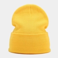 Close-up of bright yellow beanie showing fine vertical knit texture and cuffed design - Yellow
