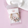 Detail view of woven shell bracelets with faux pearls in transparent OPP packaging - White Unicorn Display Cards
