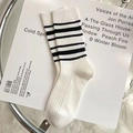 Knee-high white cotton socks with black triple stripes in minimalist school style - Striped Slouch Socks (No.04 Stripe)