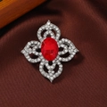 Vintage style silver brooch featuring a large oval red ruby and sparkling rhinestones - Style 15 (Ruby + Silver)