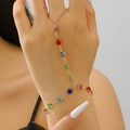 Detailed view of a gold hand harness featuring vibrant multi-colored rhinestones and rings - Rainbow Rhinestone Prong Setting Hand Chain Bracelet (K-1086) / KC Gold