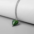 Close-up of heart-shaped green glass pendant with gold foil on silver chain - Steel - Dark Green