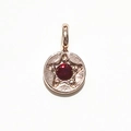 Rose gold round pendant featuring an embossed star and a deep red gemstone center - Rose Gold January