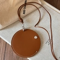Detail of round brown faux leather magnetic glasses holder with white stitching - Brown Earphone Storage Bag