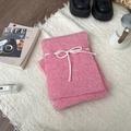 Pink knit scarf featuring white bow design with soft texture on beige background - Scarf / Pink