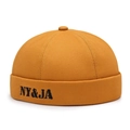 Mustard yellow cotton docker cap featuring black NY&JA letter embroidery on the front - Adjustable / Yellow