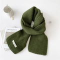 Minimalist green knitted winter scarf with brand tag on a clean white aesthetic background - Green