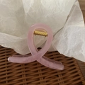 Pink translucent resin hair claw clip with golden spring on a woven tray - Bright Pink