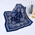 Detail of soft navy silk scarf with white paisley pattern and elegant folds on table - Navy Blue Paisley