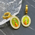 Golden oval Virgin Mary earrings with white crystal halo on black marble surface - Oval Portrait Earrings