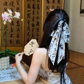 Detailed view of white silk hair ribbon with black calligraphy ink print on a braid - 1# Claw Clip - White with Black Ink (Calligraphy)