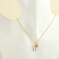 Detailed view of gold Christmas stocking pendant with colorful dots and candy cane on a bust - Christmas Sock
