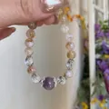 Artistic gold rutilated quartz bracelet with purple amethyst bead on hand - Yellow Tower Crystal & Amethyst Bracelet