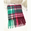 Detailed view of woven green and wine red plaid scarf featuring soft fringe tassels - Green Red