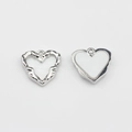 Detailed view of silver heart charms featuring textured finish and white enamel inlay - White-Silver