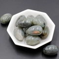 Polished grey labradorite egg-shaped gemstones with blue shimmer in a white tray - Labradorite (1pc)