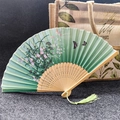 Classic green floral Chinese folding fan with wood carving and decorative tassel - Butterfly Flying Flower - Light Green