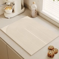 Minimalist beige kitchen drying mat with textured concentric arcs on countertop - Geometric Curvature
