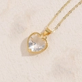 Classic gold chain necklace featuring a large clear glass heart pendant on beige leather - White Zirconia