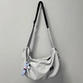 Light grey nylon crescent crossbody bag with astronaut pendant and adjustable strap - Gray + Astronaut