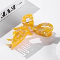 Large tortoiseshell marble pattern acetate hair claw clip for women on white background - Orange Spotted