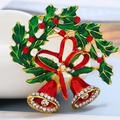 Detailed close-up of Christmas bell brooch with red crystals and green enamel leaves - BR1621 KC Gold Holly Bell
