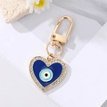 Herz-Schlüsselanhänger in Gold mit blauem Evil Eye Emaille und Strass-Besatz - Strass Emaille Herz Blaues Auge