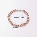 Close-up of amber cubic zirconia bracelet with silver-plated base and secure metal clasp - Champagne