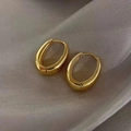 Close-up of gold oval hoop earrings with polished thick walls on grey silk fabric - Oval Chunky Hoop / Gold