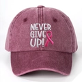Close-up of NEVER GIVE UP embroidery and pink ribbon on washed burgundy baseball cap - Burgundy