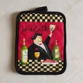 Red cotton oven mitt pad with Wine and Dine illustration and checkerboard pattern trim - Cheers