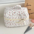 Detailed macro of a quilted cotton floral makeup bag with pink roses and ribbon puller - Rose Bow [Cosmetic Bag]