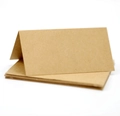 Detailed view of folded brown kraft paper place cards on a clean white background - Kraft Paper