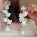 Detailed view of long tassel earrings with white fabric flowers and faux pearls - 24# Silver Pin - White (Extra Long Fabric Flower Pearl Tassel)