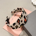 Korean style plush leopard print knitted headband with handmade label on a minimal pink setup - White