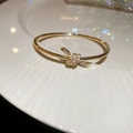 Macro view of 18k gold plated snake twist bracelet with shimmering zircon crystals - 26# Golden Knot