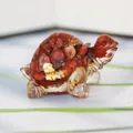 Turtle shaped resin figurine with red crystal stone and gold foil inside on white surface - Red Jasper + Gold Foil