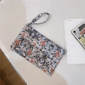 Detailed top view of a floral cotton wristlet bag for phones and small accessories - Vintage Black Red