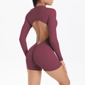 Close-up of the backless design and scrunch butt detail on burgundy fitness romper - Burgundy
