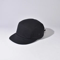 Detail view of a 5-panel black camping cap with metal side eyelets and plain fabric texture - Black