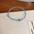 Aquamarine blue beaded bracelet with silver spacers on a minimalist display tray - Style 109 (Aquamarine Style) / Blue