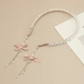 Detail of pink crystal headband featuring silver tassel chains and elegant ribbon bows - Pink