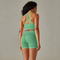 Detail of seamless mint green yoga set featuring cross-back sports bra and high-waist shorts - S / Top And Bottom / Cross Bra + Shorts / Light Green