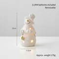 White ceramic snowman LED figurine with gold details and star-shaped light glow, 12cm height - Bell Snowman