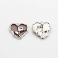 Macro shot of purple enamel heart charm with silver rose and textured metal back - Brown-Silver