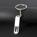 Silver metal keychain featuring a hollowed-out letter W pendant on a black pedestal - Letter W