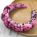 Pink and black leopard print padded headband with a braided velvet texture on a tray - Segmented Padded Headband / Velvet Pink Leopard