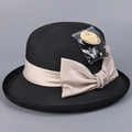 Detail of black straw sun hat showing UPF 50+ protection tag and champagne bow ribbon - M(56-58cm) / Black