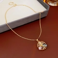 Macro detail of gold flower pendant with pink and blue zircons on a jewelry tray - Hollow Colorful Zirconia Flower Necklace (WN1236)