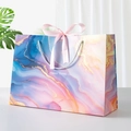 Artistic marble textured gift bag with pink ribbon bow and Happy Times lettering - Splendid Galaxy